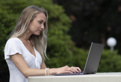 Female student works on a laptop outdoors on SCC's Jackson Campus