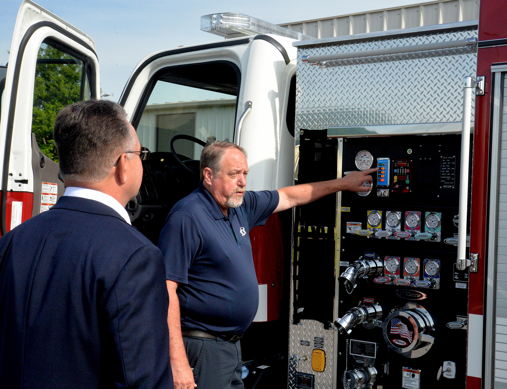 Alan McWilliams (right), SCC’s Fire/Rescue Program Director, shows N.C. Rep. Karl Gillespie the instrument panel on the college’s new fire truck that was purchased with funds. Rep. Gillespie helped secure for Southwestern.