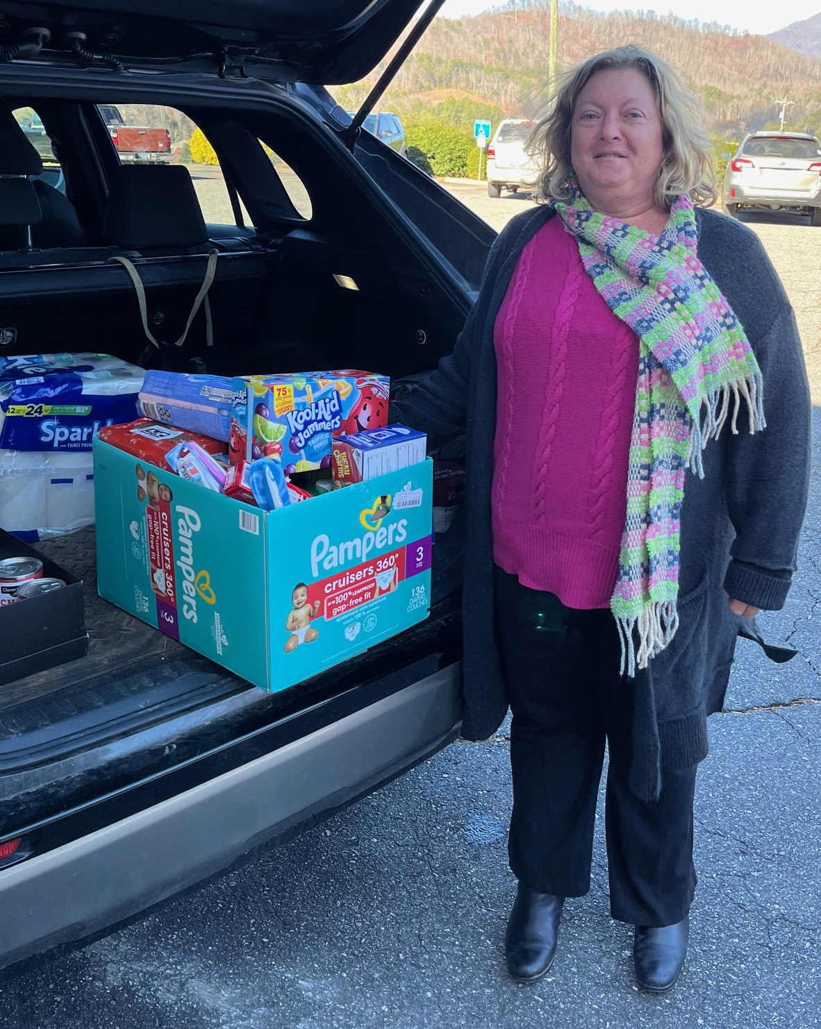 Amy Russ stands beside groceries purchased for a student