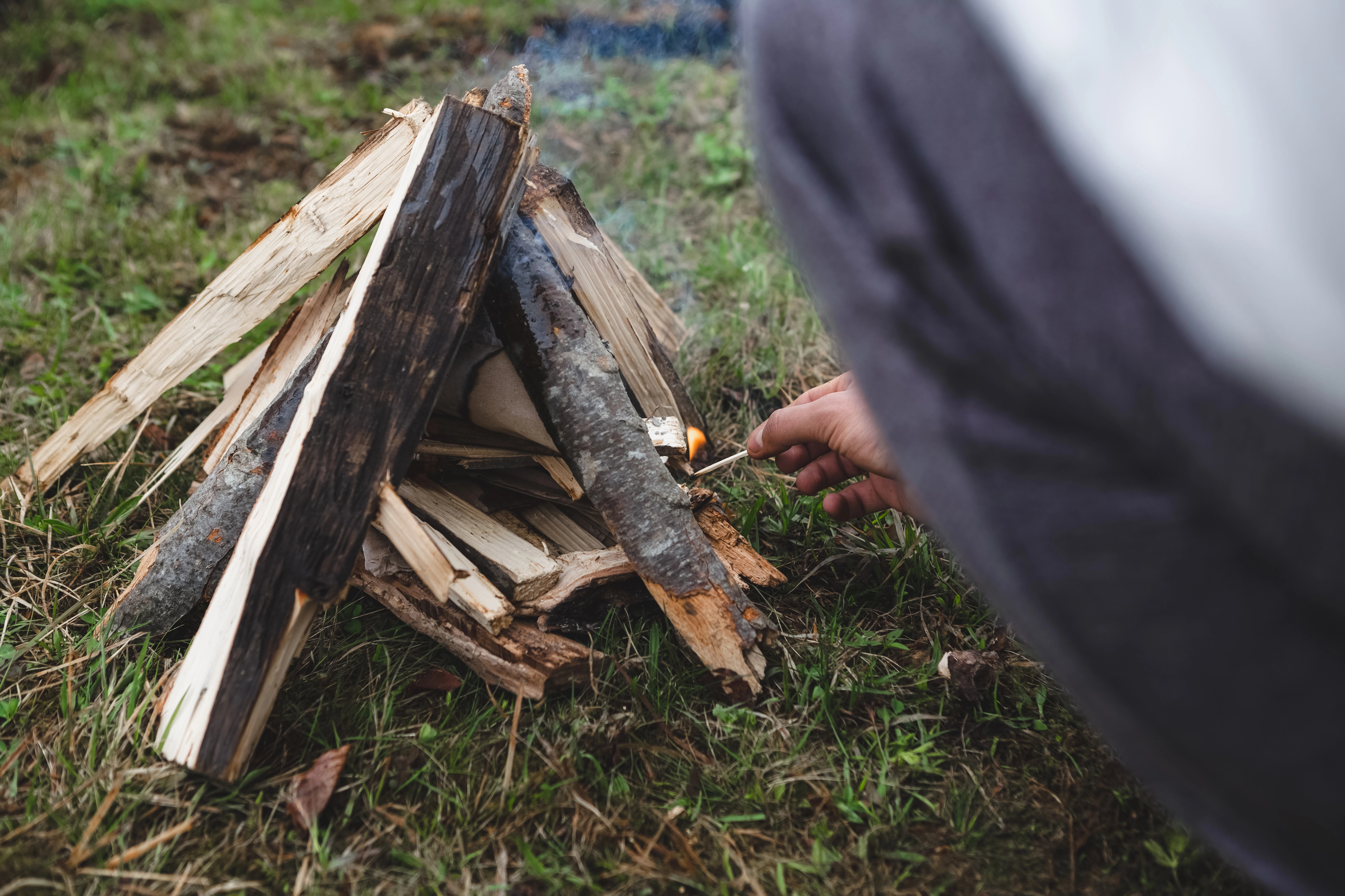 Individual starting a campfire