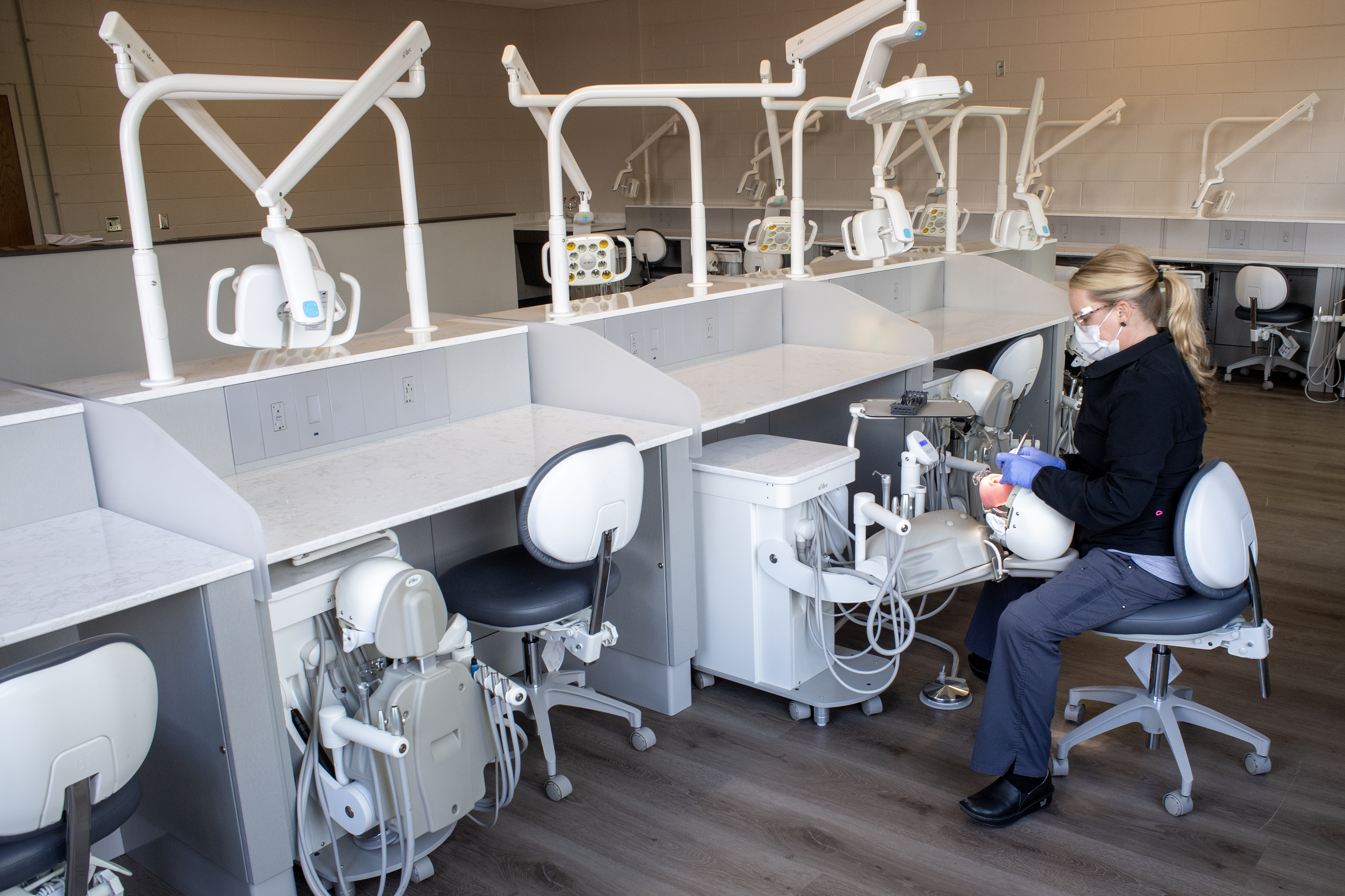 woman works on manekin in lab environment