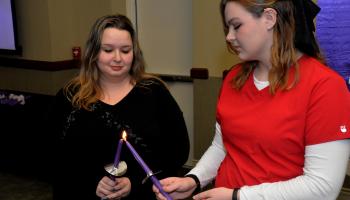 Inductees light their candles