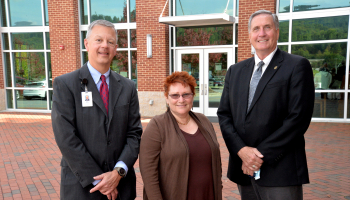 Nancy Bergenstock stands beside Brett Woods and Dr. Don Tomas.