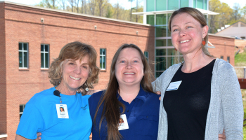 Three ladies stand in front of the Burrell Building on SCC's Jackson Campus