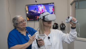 Jill Ellern, SCC’s Director of Healthcare Simulation Learning, shows Nursing student Mandy Tessin how to use some of the new virtual reality headsets located in the Don Tomas Health Sciences Center on Southwestern’s Jackson Campus.