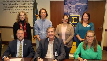 SCC and ETSU representatives sign the agreement.