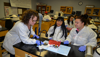 Three people work on blood sampling project at SCC.