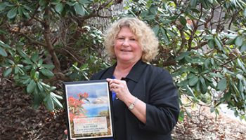 Kay Wolf pictured with the award she and the English Learners Team received.