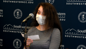 Female student speaks into a microphone.