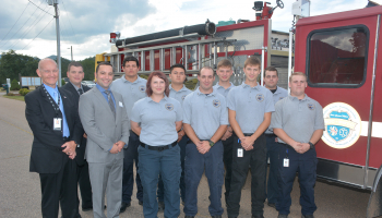 SCC Fire Academy graduates standing in front of fire truck.