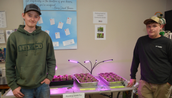 Students Payton Ball and JT Neugin planted seeds as a community service project in an effort to help the Cullowhee Community Garden.
