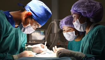 Surgeon and Surgical Tech work together in operating room.