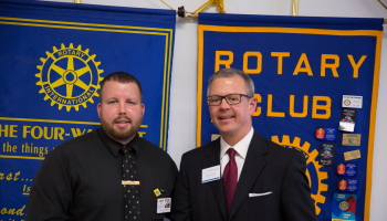 Picture of Sylva Rotary president Eddie Wells (left) shaking hands with SCC Foundation director Brett Woods.
