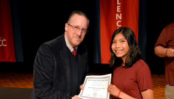 Student receives certificate from principal