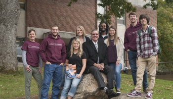 In this 2018 photo, Dr. Tomas is surrounded by SCC students on the Jackson Campus.