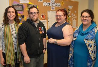 Three ladies stand beside a male SCC student inside a building on WCU's campus.