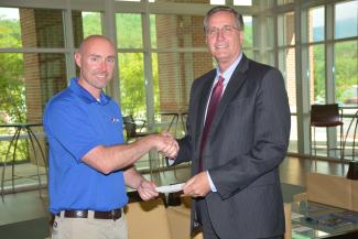 Photo of Pepsi representative presenting a check to SCC president.