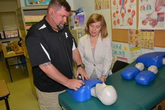 Man and woman standing behind table