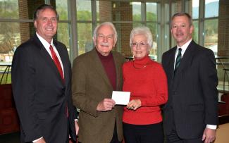 Three men and a woman pose for a photo inside a building on SCC's Jackson Campus.