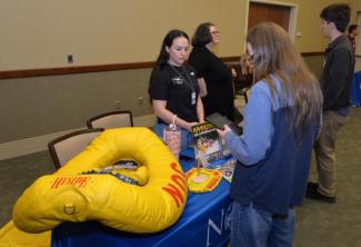 Inductees stand in front of the stage.
