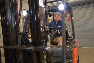 Man operates forklift