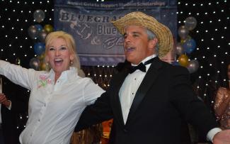 Man and woman celebrate in front of the stage during the gala.