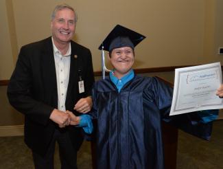 Andy Watty of Sylva (right) proudly shows off his diploma after receiving it from Dr. Don Tomas (left), SCC’s President.