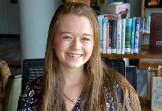 Woman sits in library
