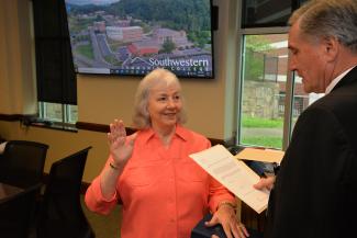 Joyce Cooper is sworn in by Dr. Don Tomas
