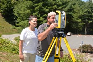 SCC instructors check out surveying equipment.