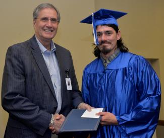 Graduate receives diploma from SCC President