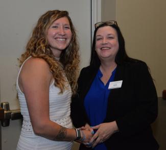Katelynn Ledford-McCoy (left) of Cherokee received her pin from Crystal Rhynes, Human Services Technology program coordinator.