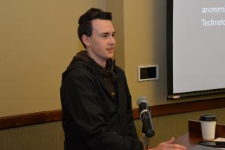 Student speaks to a crowd in the fall.