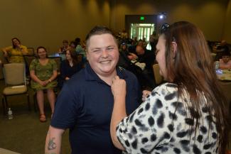 Brittany Martin receives her pen from program coordinator Crystal Rhynes