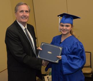 Graduate receives Adult High School diploma at a recent ceremony.
