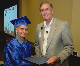Graduate receives diploma