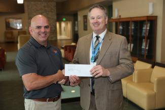 Pepsi Area Manager Thomas Hibbs (left) presents a $6,000 check to Evan Hatch, SCC’s Executive Director for Institutional Advancement. A portion of the gift will go to SCC’s Student Emergency Fund while the rest secures a Diamond-level sponsorship for Pepsi at the 12th annual Boots, Blue Jeans &amp; Bling Gala – set for Sept. 26 at Harrah’s Cherokee Casino Resort.