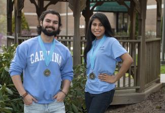 Students wearing UNC shirts stand in front of a gazebo