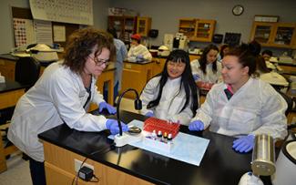 Three people work on blood sampling project at SCC.