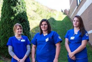 Photo of two graduates preparing to enter auditorium for the ceremony.