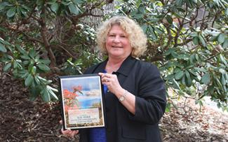 Kay Wolf pictured with the award she and the English Learners Team received.