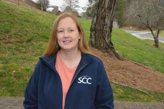 Woman stands outdoors