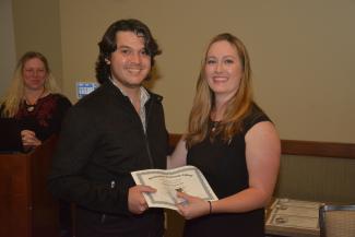 Student received a certificate from his instructor.