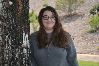 Young lady poses near a tree on SCC's Jackson Campus.