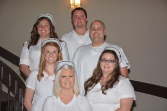 Jackson County residents standing and smiling in all white.