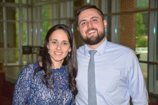A woman and man smiling at the camera