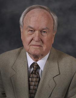 Paul Holt is pictured in a suit and tie.