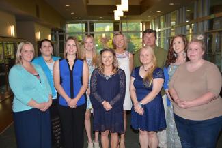Ten students standing and smiling