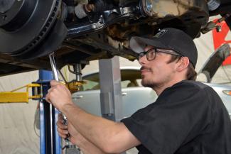 Mechanic works on an automobile
