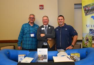 Three men at a job fair